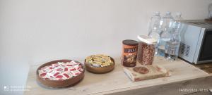 a table with two cakes and bottles of water at Al Green House in Rome