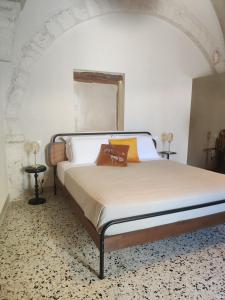 a bedroom with a bed in a white room at Caterina's Suites & Apartament in Ostuni +37 photos