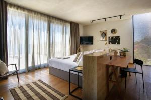 a hotel room with a bed and a desk at Villa Eleven in Dubrovnik +29 photos
