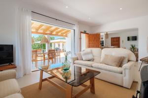 a living room with a couch and a table at Can Joan Durban in Sant Joan de Labritja