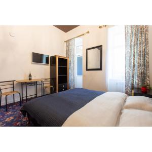 a bedroom with a bed and a table and a desk at "Wine palette" on Skovoroda Street, 56 in Kharkiv