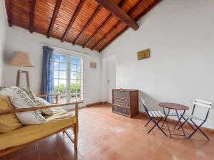 a living room with a couch and a table at Détente provençale avec vue mer in Sainte-Maxime