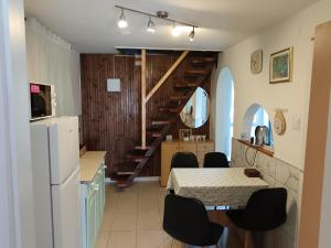 a kitchen with a table and chairs and a refrigerator at Enjoy the silence in Rezi