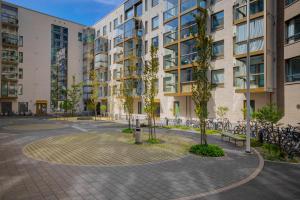 a courtyard in front of a building with bicycles at Modern and Stylish 1BR with Balcony and City View in Helsinki