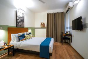 Postel nebo postele na pokoji v ubytování Olive Hotel Magrath by Embassy Group
