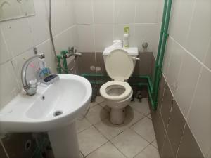 a bathroom with a white toilet and a sink at Hana hostel not for Egyptian in Hurghada