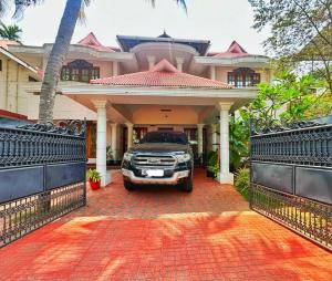 特里凡得琅La Casa Trivandrum 4 BHK AC Luxury Villa at City Centre, Just 5 kms from Airport & 3 Kms to Trivandrum Railway Station的停在房子前面的卡车