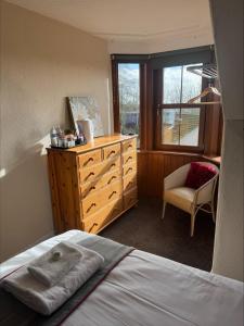 a bedroom with a bed and a dresser and a window at The Hillside Hotel & Restaurant in Hillside +53 photos