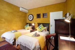 Ένα ή περισσότερα κρεβάτια σε δωμάτιο στο Bluegum Country Lodge +8 φωτογραφίες