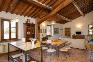 a living room with a table and chairs and a couch at Podere le Rote in Castelnuovo di Val di Cecina