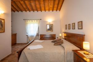 カステルヌオーヴォ・ディ・ヴァル・ディ・チェーチナにあるPodere le Roteの部屋の中に大きなベッドがある寝室 +25枚の写真