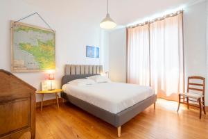 a bedroom with a bed and a map on the wall at Plage 300m Bleu Salé 4 Ch in Le Guilvinec