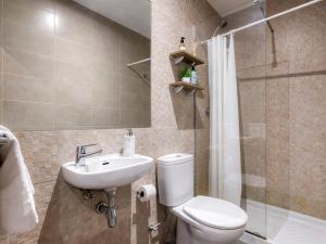a bathroom with a toilet and a sink and a shower at Livensa Living Studios Valencia Marina Real Hotel-Apartamento in Valencia