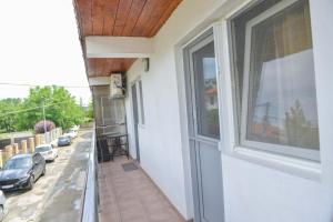 a balcony with a window and a view of a street at Apartament A2 - EVIM in Mangalia