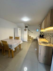 a kitchen with a table and a refrigerator at Apartament A2 - EVIM in Mangalia
