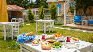 a white table with food on top of it at Limonata Bozcaada ex Vina Garden in Bozcaada