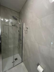 a bathroom with a shower with a glass door at Brand new apartment in Paceville, St Julians in St Julian's
