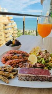 a plate of food and a glass of orange juice at F10 - Vila D Orpesa X, World Lujo - ServHouse in El Borseral