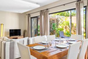 a dining room with a wooden table and chairs at Tropical Villa - 3 Bedrooms in the heart of Grand-Baie in Grand Baie +15 photos