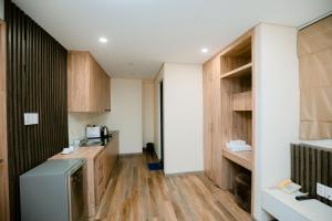 a kitchen with wooden cabinets and a refrigerator at Happy Home Hotel in Vung Tau +39 photos