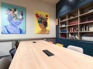 a conference room with a wooden table and bookshelves at Livensa Living Studios Valencia Marina Real Hotel-Apartamento in Valencia