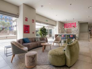 a living room with couches and chairs in a store at Livensa Living Studios Valencia Marina Real Hotel-Apartamento in Valencia