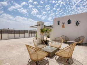 a group of chairs and a table on a patio at Livensa Living Studios Valencia Marina Real Hotel-Apartamento in Valencia