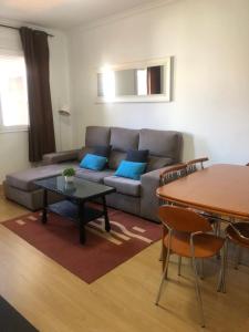 a living room with a couch and a table at Gaviota 2do in Marín