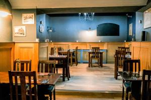 a dining room with tables and chairs in a restaurant at The Hillside Hotel & Restaurant in Hillside
