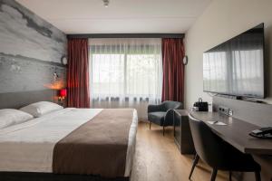 Postel nebo postele na pokoji v ubytování Bastion Hotel Almere