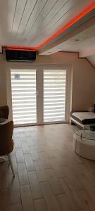a large room with two windows and a bed at RB Apartment 1 (SPA) & 2 in Palić