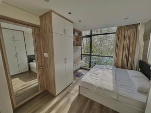 a bedroom with a bed and a large window at Happy Home Hotel in Vung Tau