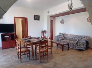 a living room with a table and chairs and a couch at Tassos Holiday home in Archangelos