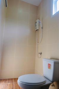 a bathroom with a toilet and a shower at Nam Sai Loft Resort in Chao Lao Beach
