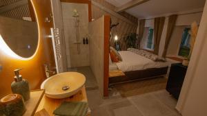 a bathroom with a bed and a sink and a shower at Moulin Lombard B&B Chambre et table d Hôtes Massages & Bien-être in Les Arcs sur Argens +100 photos