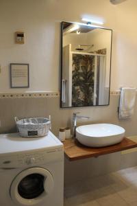 a bathroom with a sink and a washing machine at Domo Marzellinu in Orosei +28 photos