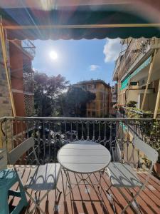 a balcony with a table and chairs on a balcony at Sail Away Camogli in Camogli
