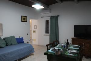 a living room with a couch and a table at Domo Marzellinu in Orosei