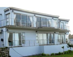 a white house with a large balcony on it at Crayfish in Vredenburg