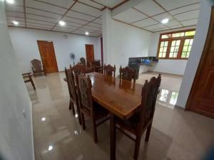 a dining room with a wooden table and chairs at Forest Glen Nest Ella in Bandarawela