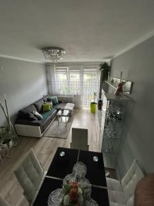 a living room with a table and a couch at BM Apartament in Augustów