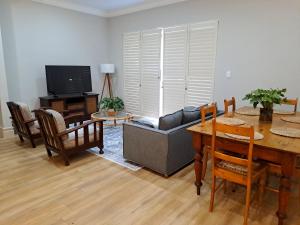 a living room with a table and a couch at Keerweder in Ceres
