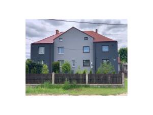 a white house with a red roof at Drivers in Wożniki