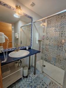 a bathroom with a sink and a shower at Alojamientos el Paramo in San Vicente de la Barquera +115 photos