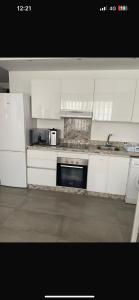 a kitchen with white cabinets and a sink at Studio luxueux et contemporain in Casablanca