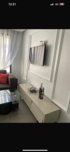 a living room with a table and a couch at Studio luxueux et contemporain in Casablanca +2 photos