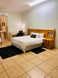a bedroom with a large bed and a desk at Crayfish in Vredenburg