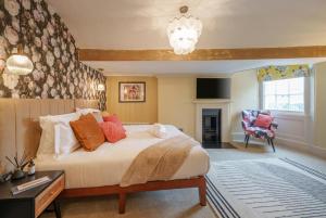 a bedroom with a large bed and a chair at Tellers secret loft apartment The Bank of England in Bristol