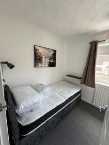 a bedroom with a bed in a room with a window at Braemar House - 3 Bedroom, Sleeps 5 in Stockton-on-Tees