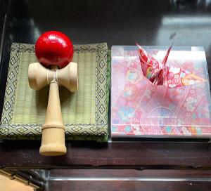 a wooden spoon with a red apple on top of a box at 藤花楼akagawa 登録文化財 in Osaka